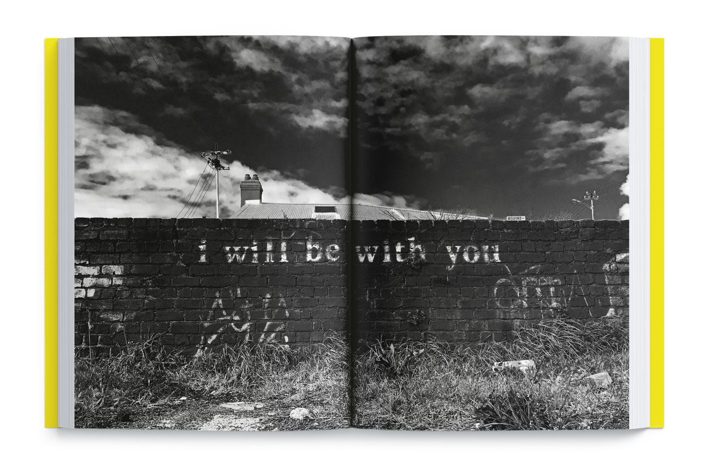 A graffiti slogan message written on a wall "I will be with you" in Woodstock, Cape Town, South Africa.