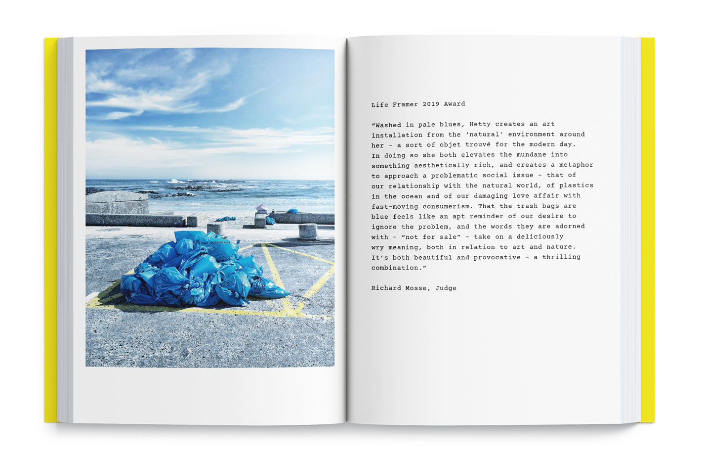 A page from "Cape Town as a State of Heart" a book by So Splendid Agency, photograph of blue plastic garbage bags against the backdrop of the Atlantic Ocean by Hetty Zantman in Blauwberg Strand, Cape Town, South Africa. Hetty Zantman was one of the winners of the 2019 Life Framer Award. Richard Mosse was the Judge.