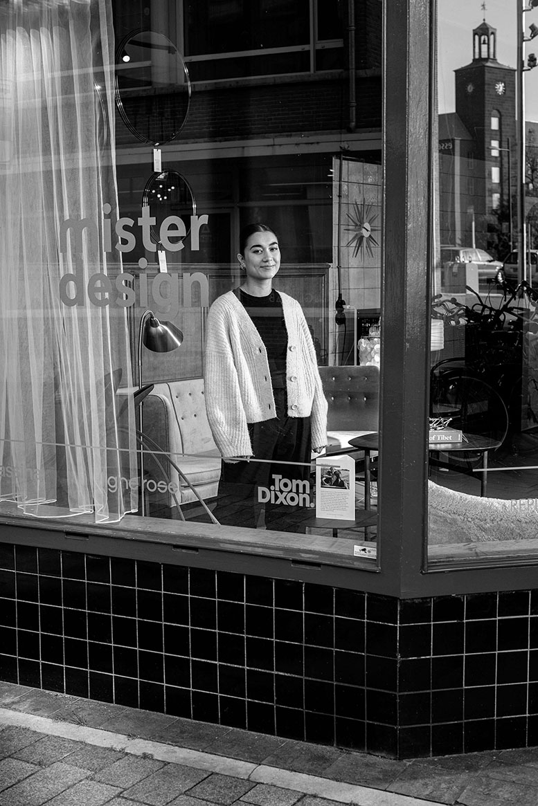 MisterDesign a showroom for modern and classic design, furniture retailer in Den Bosch, Netherlands. Bobbie Flissinger shop assistant looking through the window.