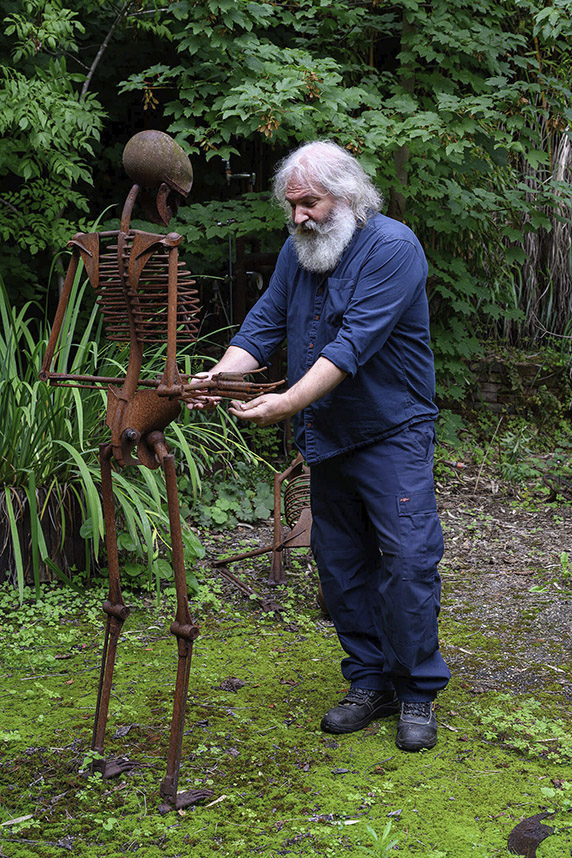 Wolfgang Oude Hengel with a lifesize sculpture in his garden Mönchengladbach, Germany.