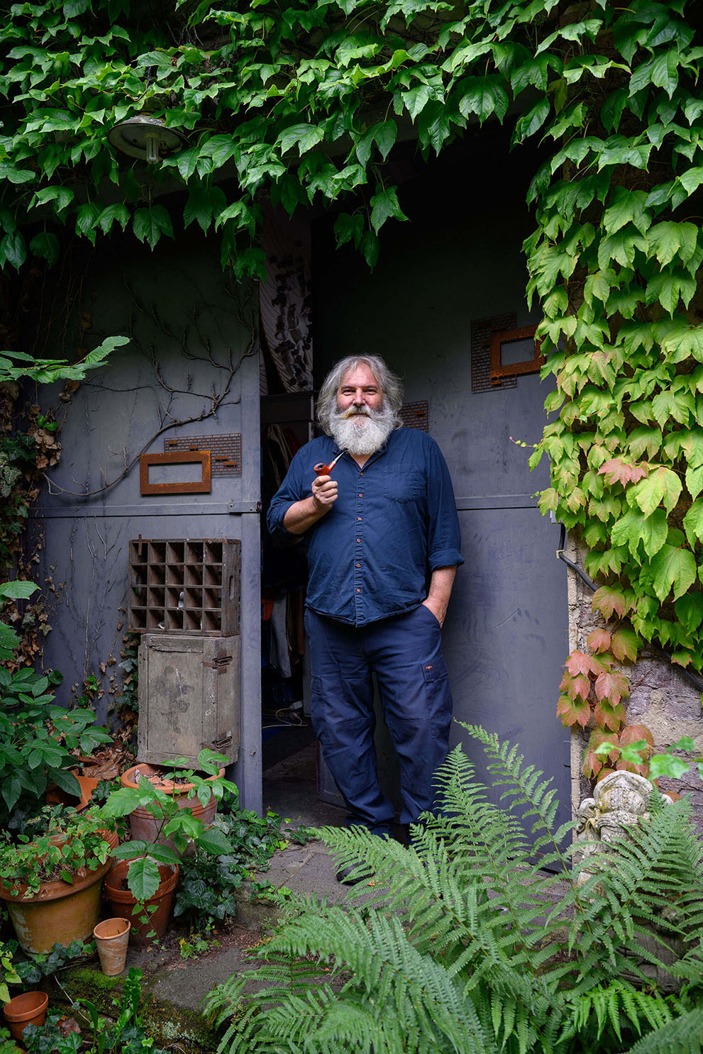 Wolfgang Oude Hengel, sculptor, standing in the doorway of his studio in Mönchengladbach, Germany.